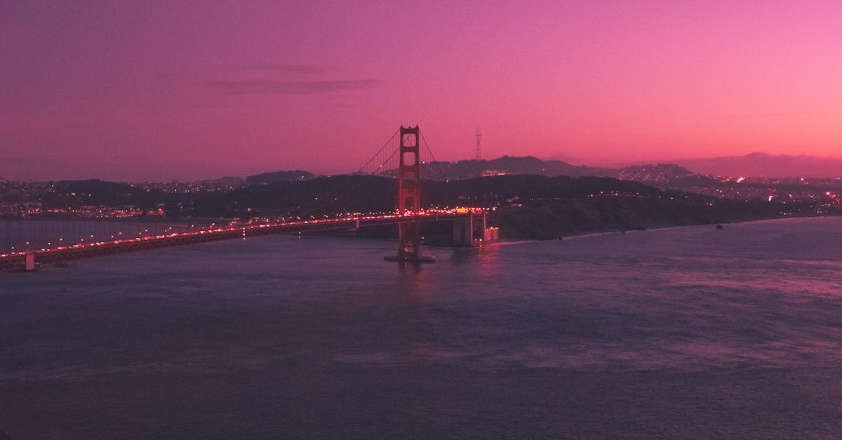 Dramatic view of Golden Gate Bridge under a vivid purple sky at dusk.