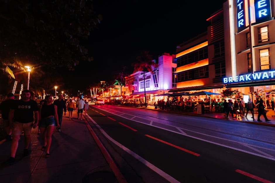 Explore the vibrant nightlife with neon lights and crowded streets on Miami's famous Ocean Drive.